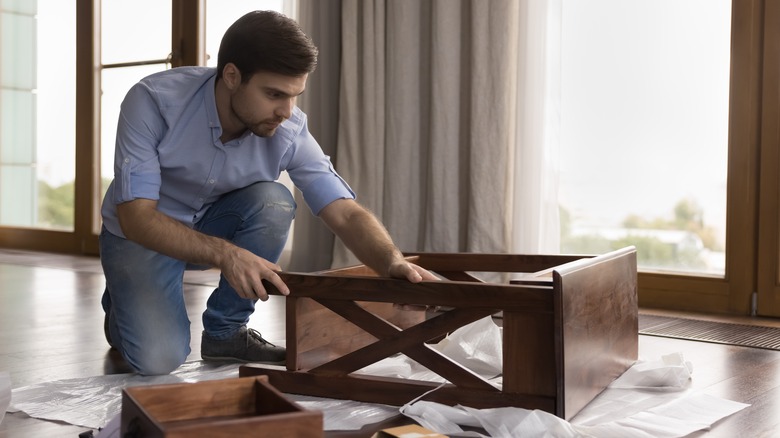 man fixing table