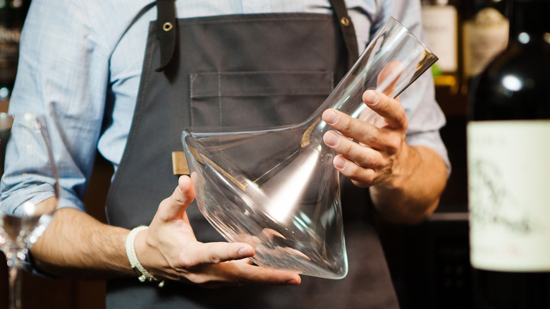 man holding decanter