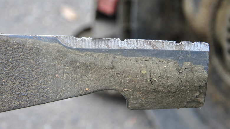 Lawn mower blade with nicks and dents in its edge