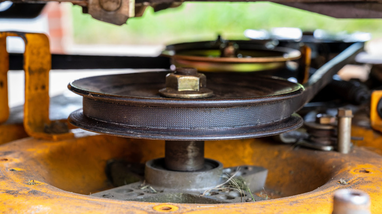 A close-up shot of lawn mower deck and blade spindle