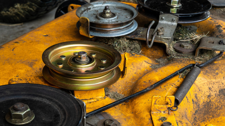 Close-up view of a lawn mower deck showing multiple spindles