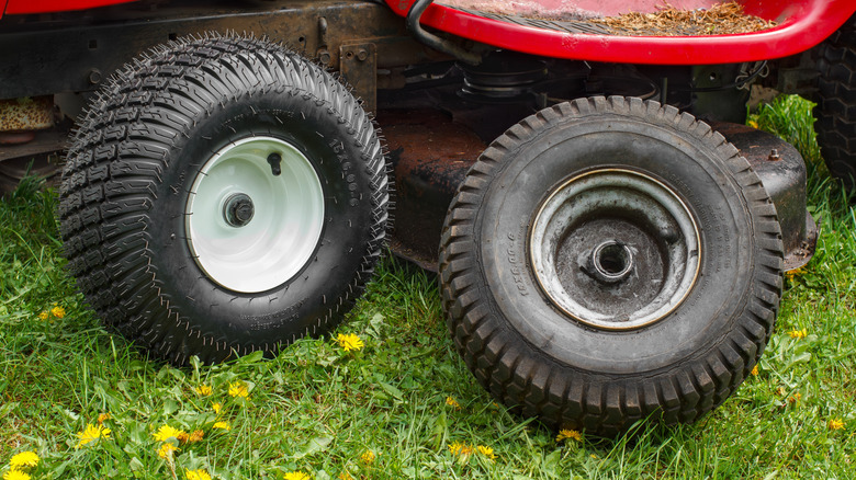 A wheel removed to replace the riding lawn mower brakes