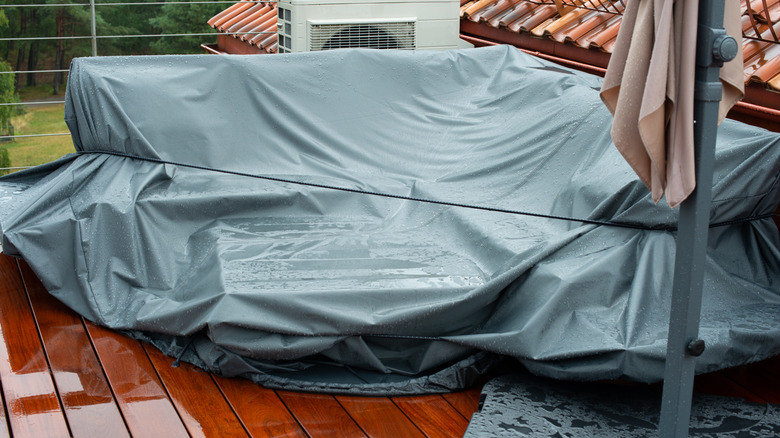 Outdoor patio furniture is covered up so rain does not cause damage
