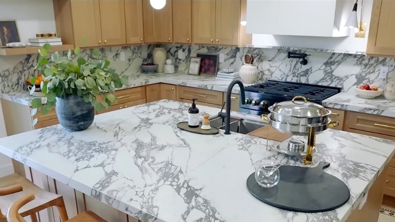 Christina Haack's The Flip Off kitchen featuring marble counters and wood cabinets