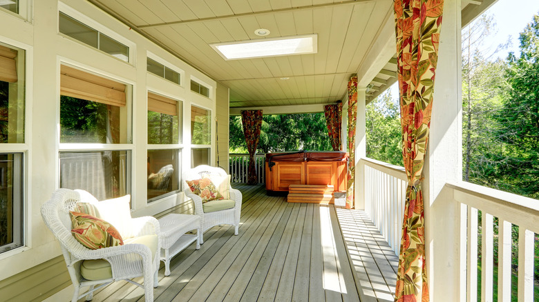 Curtains decorate front porch railing