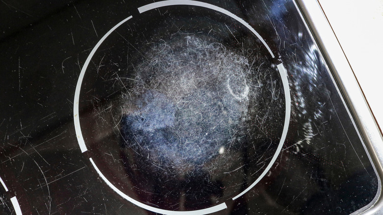 A scratched and dirty induction cooktop
