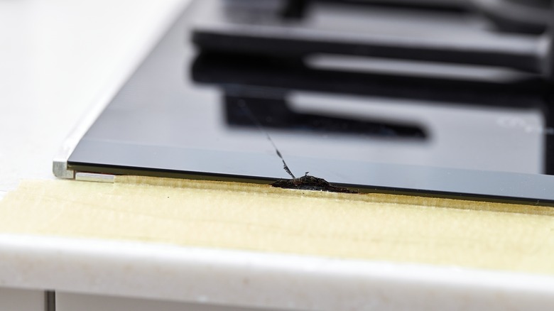 A chipped and cracked induction cooktop