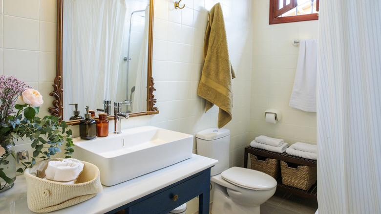 Mustard towel in neutral bathroom