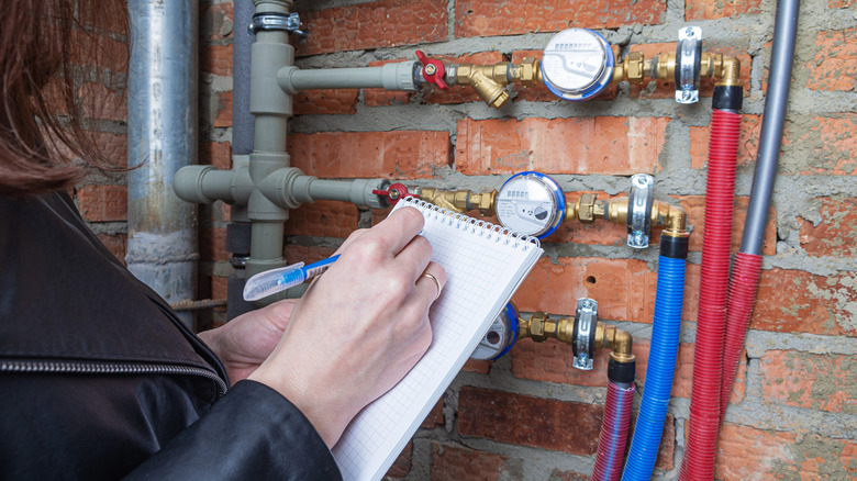 Homeowner measuring their water meter.