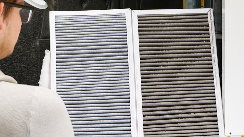 Person holding two furnace filters side by side