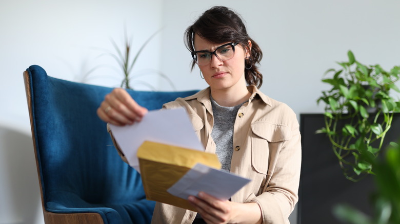 Woman holding a paper letter