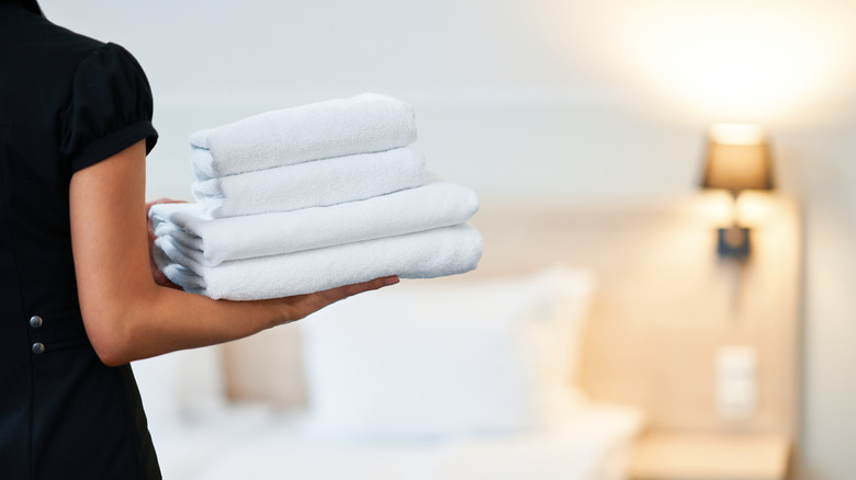 hotel maid holding fresh towels