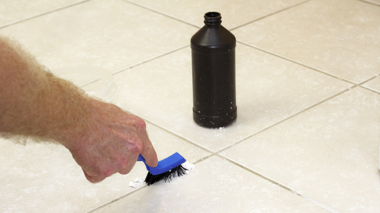 Person scrubbing tile