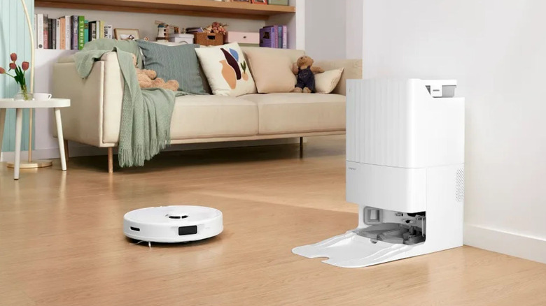 The Roborock QX robot vacuum cleaner heading back to it's base in a living room