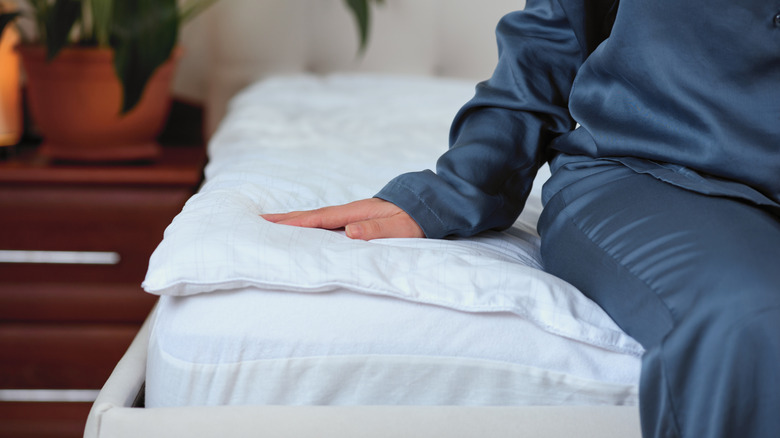 Woman sitting down on a mattress