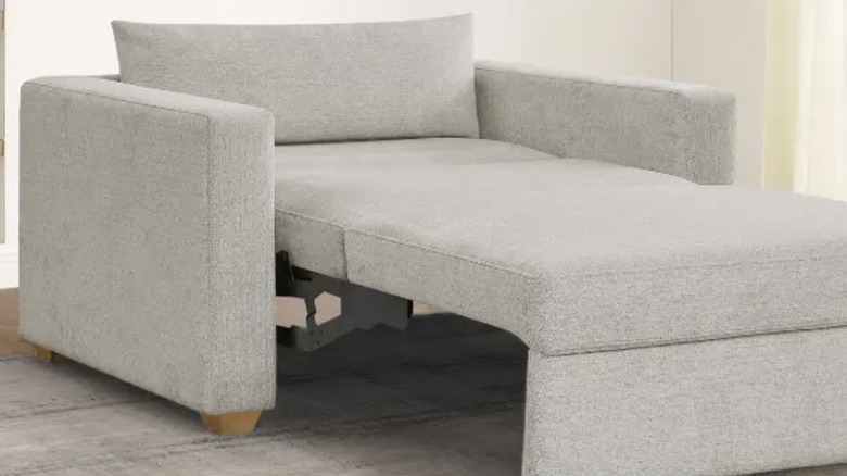 Costco sleeper chair extended into bed position in living room