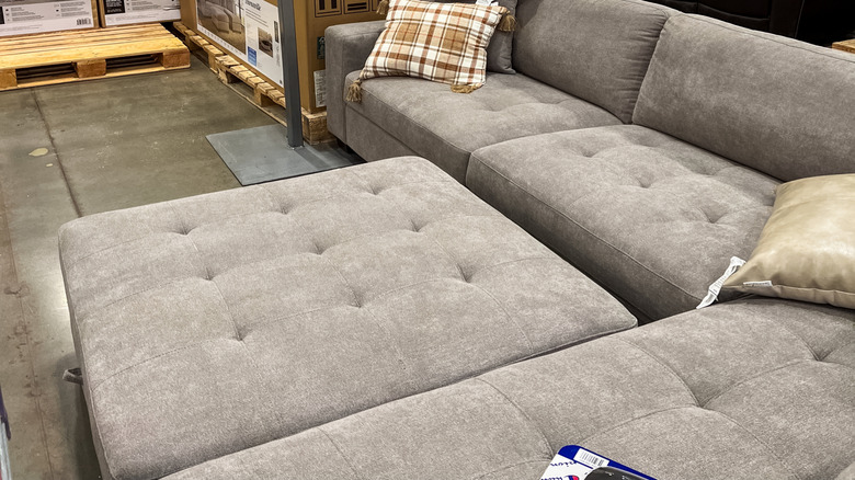 Floor model furniture in a Costco store with boxes
