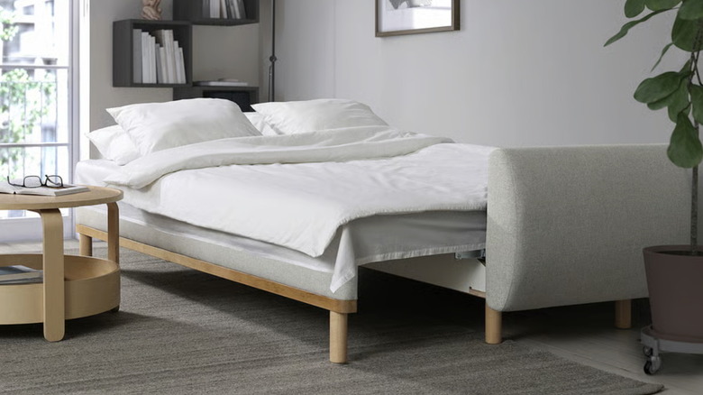 The IKEA GRUNNARP sleeper sofa in beige styled as a bed