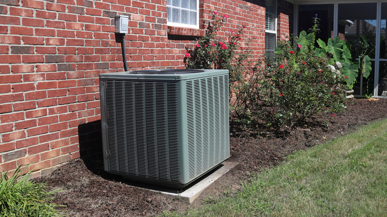 Outdoor AC unit next to brick building