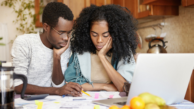 Young couple frustrated looking at finances