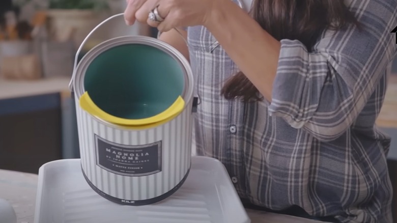 Joanna Gaines pouring a can of paint