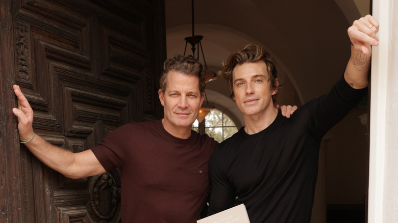 Nate Berkus and Jeremiah Brent standing in the doorway of a home