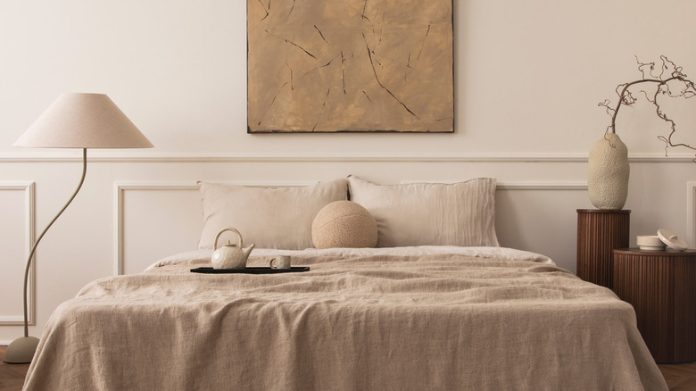 A modern bedroom with beige furnishings and decor