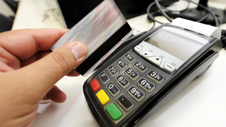Hand swiping credit card