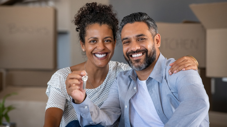 Couple with keys to home