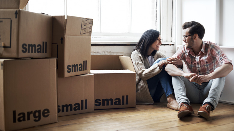 Couple surrounded by moving boxes