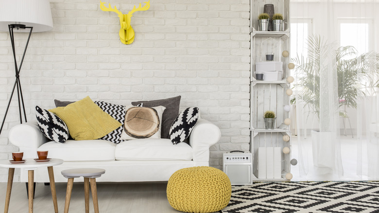 Wood accents mixed with bold rug and patterned sofa pillows