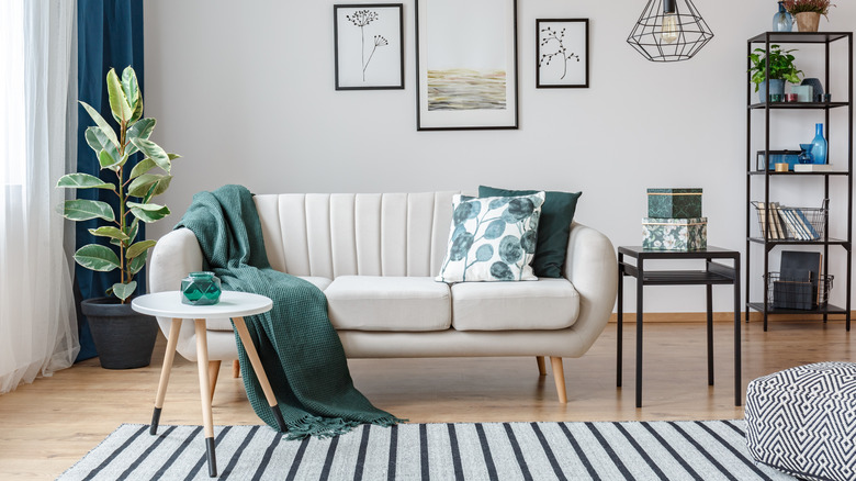Living room with striped rug and botanical-print pillows