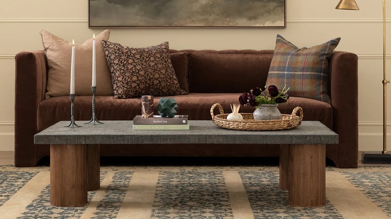 Living room couch with patterned pillows on a patterned rug