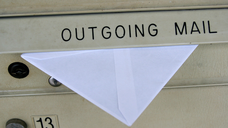 White envelope in outgoing mail box