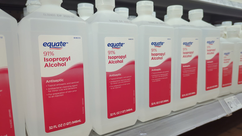 Several bottles of Equate brand isopropyl rubbing alcohol line the top of the pharmacy shelf at a Walmart store in Cary, N.C., on March 27, 2025.