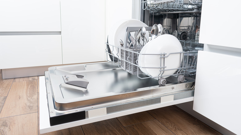 open dishwasher in white kitchen