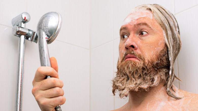 Man looking worried while showering