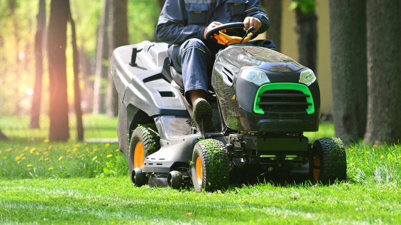 Person on riding lawn mower
