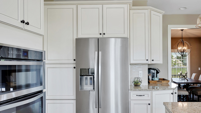 White cabinets above fridge