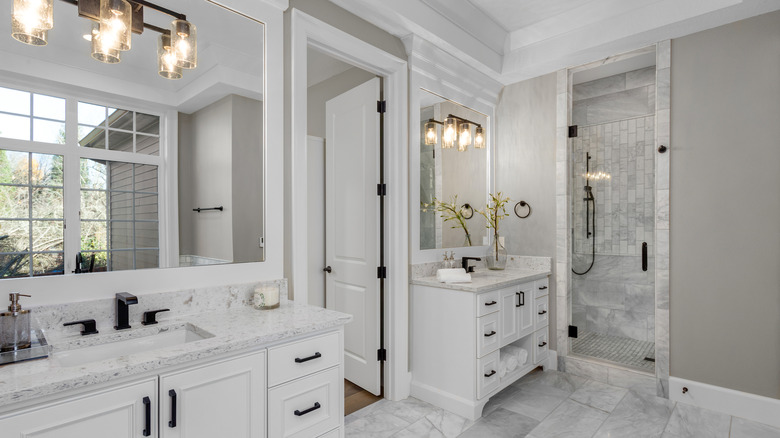two mirrors above bathroom vanities