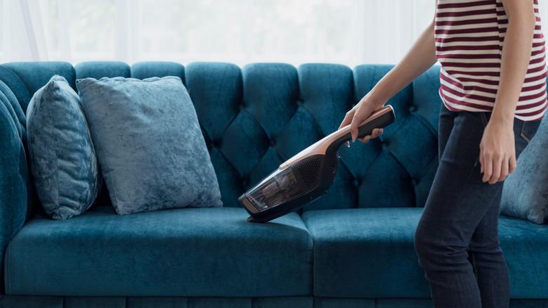 Person vacuuming couch