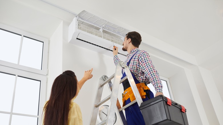 Person repairing AC unit