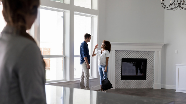 Couple touring an empty home.