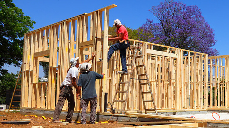 People working on building a house