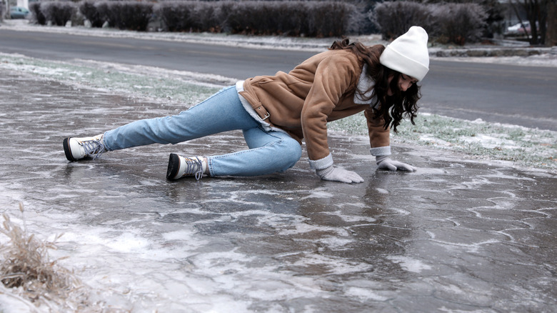 A woman who has fallen on a slippery, icy sidewalk.