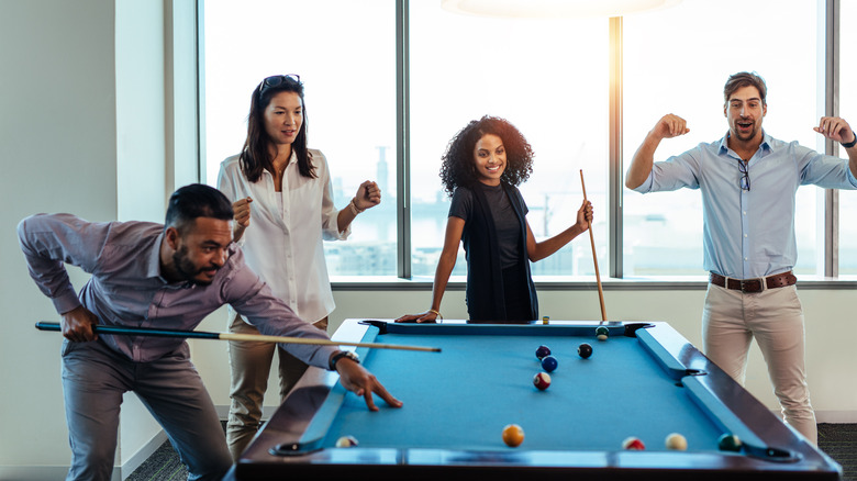 diverse friends playing pool