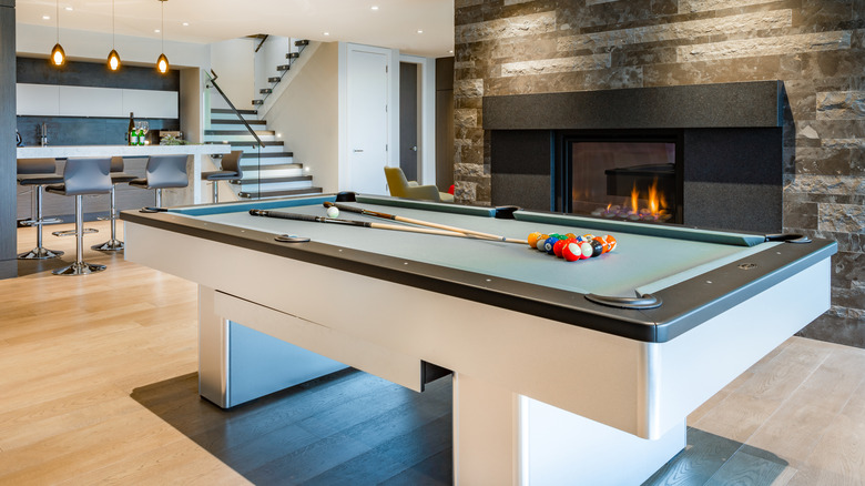 modern pool table next to fireplace