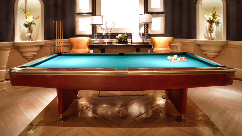 wooden pool table in contemporary rec room