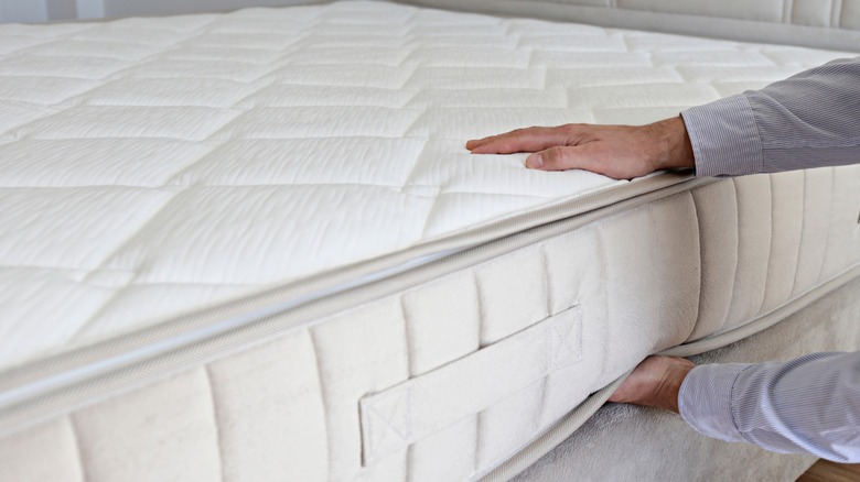 Man checking his mattress
