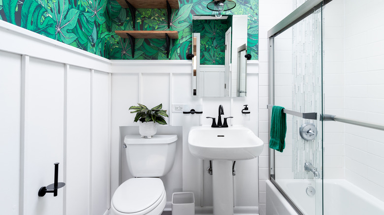 Modern bathroom with green wallpaper